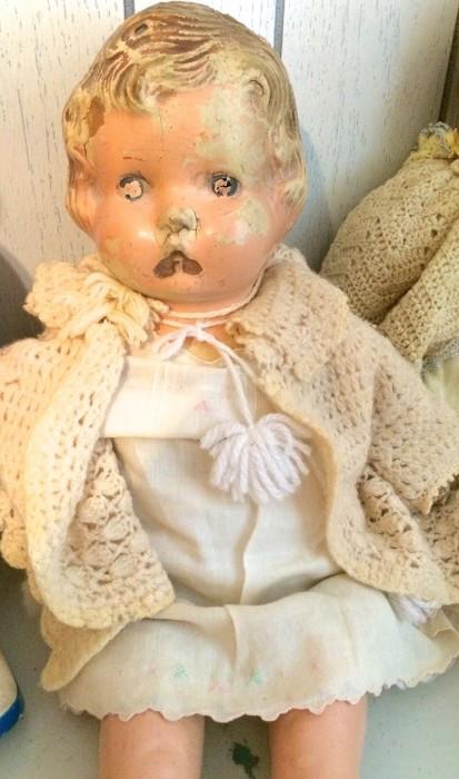 Antique baby doll girl in knitted sweater