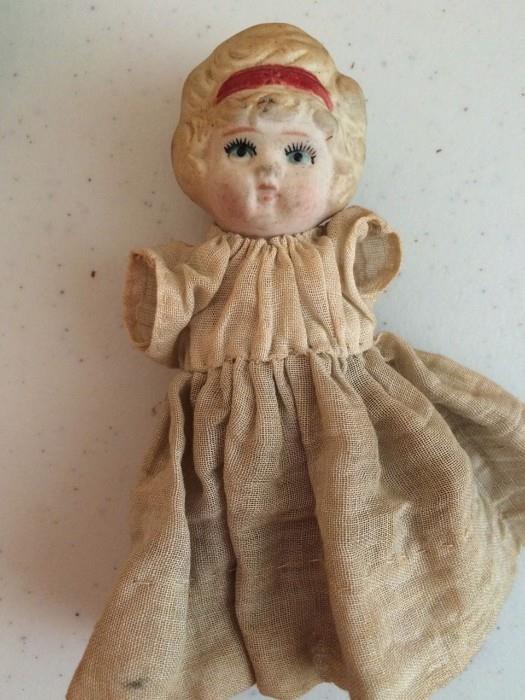 Armless bisque doll with headband