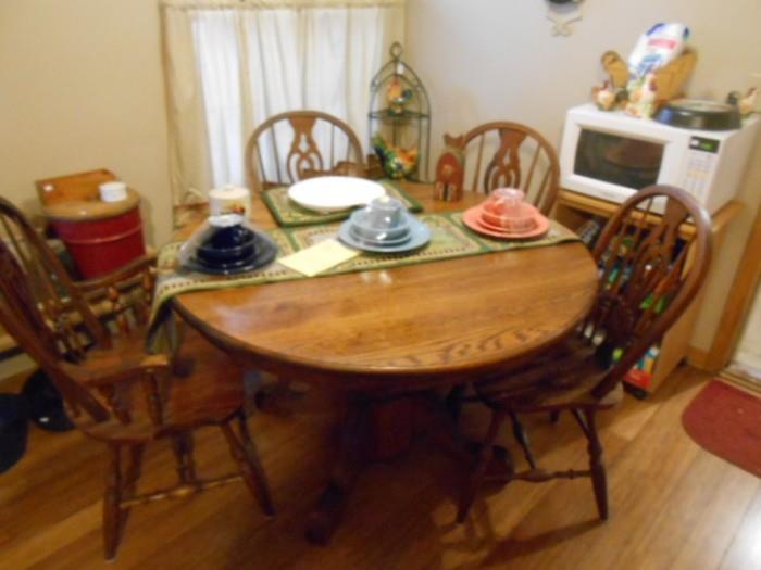 Quality made Dinaire brand  pedestal table with leaves with set of chairs, some Fiestaware sets,   microwave and stand on wheels