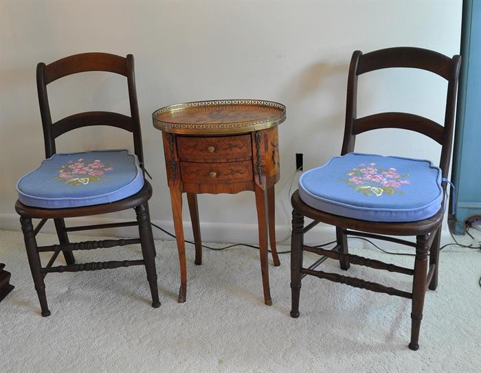 2 antique chairs with hand caned seats and needlepoint cushions with an inlaid Italian gallery rail side table