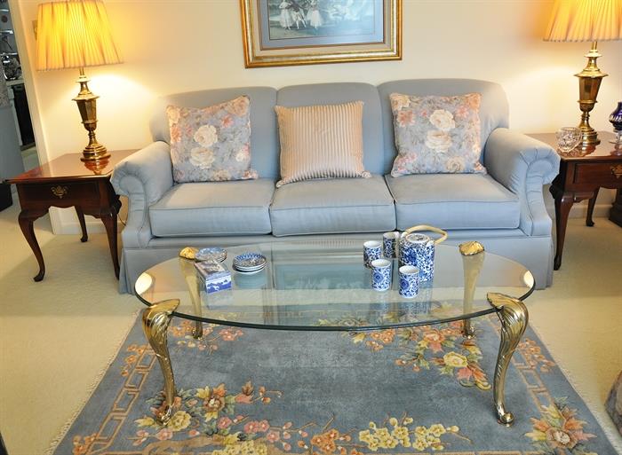 View of the custom upholstered Broyhill sofa with custom pillows, fine glass and brass coffee table, 2 Lenoir (Broyhill) end tables and pair of Stiffel lamps