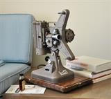 Vintage technology make such great accent pieces.  This is a Keystone movie projector with a wrinkled  finish.  It has its case, brochure, etc.