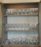 A china cabinet full of Waterford Lismore stems, Baccarat stemware and French St. Louis sherry stems