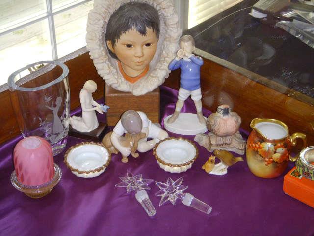 Assorted quality items in showcase including signed Clark fairy lamp, Cybis figurines, Bing & Grondahl figurines, Boehm small bird, Pickard pitcher, Waterford wine stoppers.