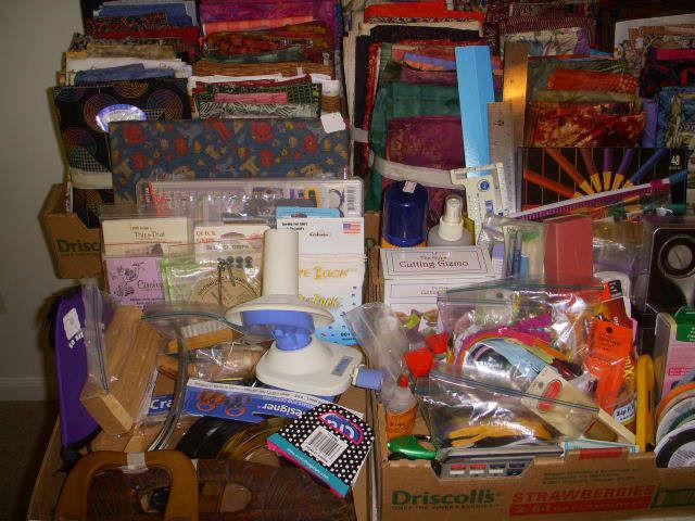 Some of the quantity of sewing and quilting supplies.  In background are some of the bundles of quality quilting fabric