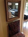 Gold framed mirror but oriental rug wrapped ottoman and pillow are not