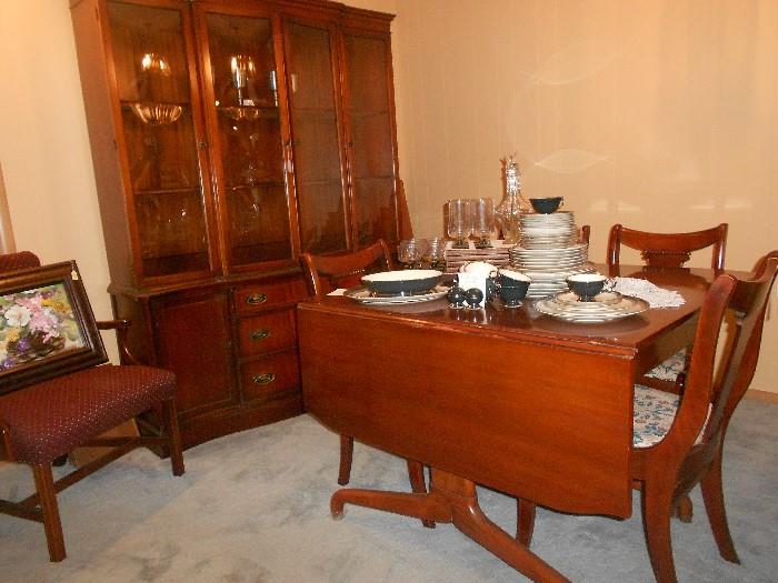 Beautiful vintage hutch and table with 4chairs also leafs  and pads.             China CONTESSA PATTERN and unique liquor decanter