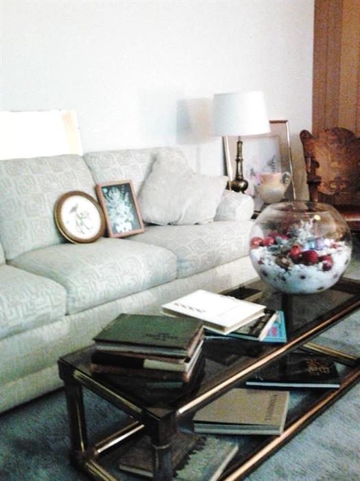 Flexsteel couch,  glass/brass tables, lamps antique yearbooks, and coffee table books.                      Beautiful Xmas terrarium.