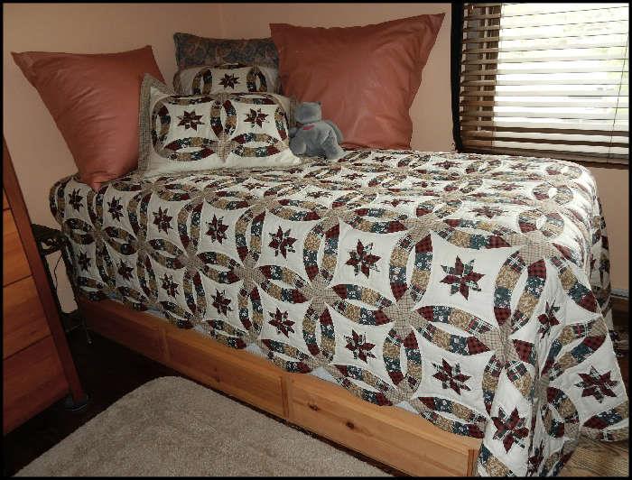 Twin bed with storage base. Gorgeous quilt