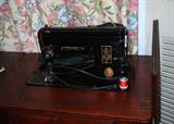 Singer sewing machine in cabinet