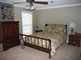 this is a very nice wrought iron and wood sleigh bed.  Bedding is super nice as well!