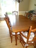 Tom Seely Solid Cherry Dining Room Table, with 10 chairs & 2 leaves. Table measure 66" Long X 42" Wide with no leaves, + 2 leaves - 12" each