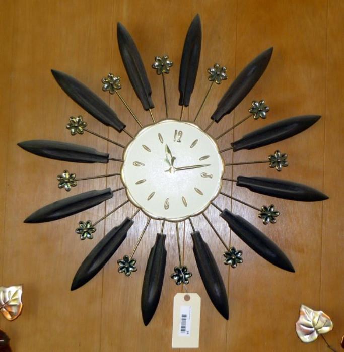 Mid Century Modern Starburst Clock with Brass Look Flower Embellishments    http://bid.auctionbymayo.com/view-auctions/catalog/id/7753/lot/987178/?url=%2Fview-auctions%2Fcatalog%2Fid%2F7753%2F