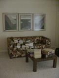 Framed artwork, queen size hide-a-bed, coffee table, and lots of books