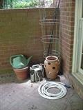 Strawberry pot, terra cotta pot, watering can, tomato stakes, other gardening essentials