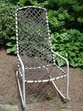 Rocker with woven straps on metal frame