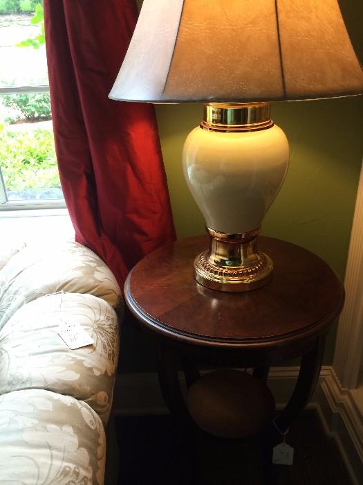    One of two matching round tables and lamps