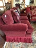                 One of the two red sofas