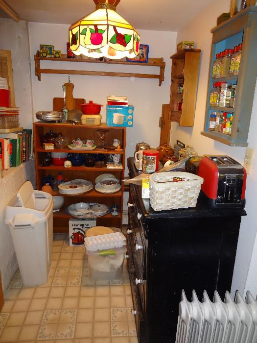 Victorian dresser, bookshelf, spice racks, cookbooks.
