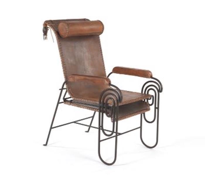 1245. Art Deco Leather and Iron Lounge Chair, possibly Jean Royere
extended 42"T x 23"W x 48"D; closed 42"T x 23"W x 34"D
Leather tied upholstery, wrought iron frame with pull-out foot rest; wood carved arm rests covered in leather; bronze tassels at the top back.
