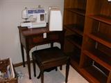 Newer brother sewing machine and an older sewing machine with bench.