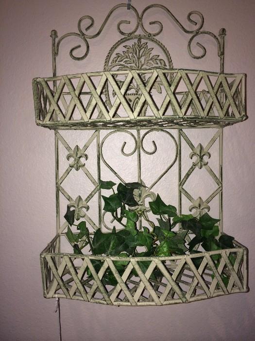          One of two iron wall shelves