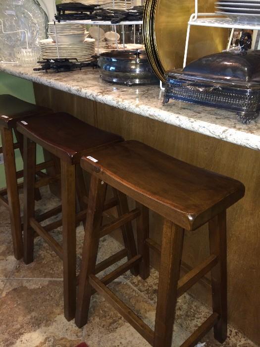         Three wooden bar stools