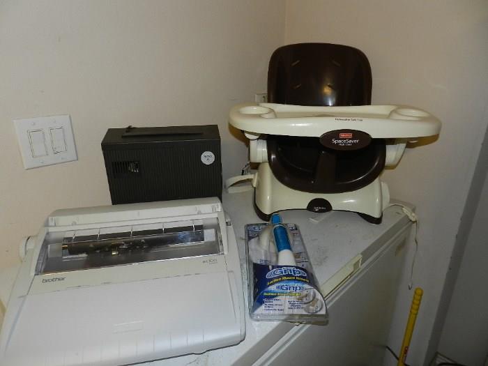 Brother typewrite, slide projector and child's portable high chair