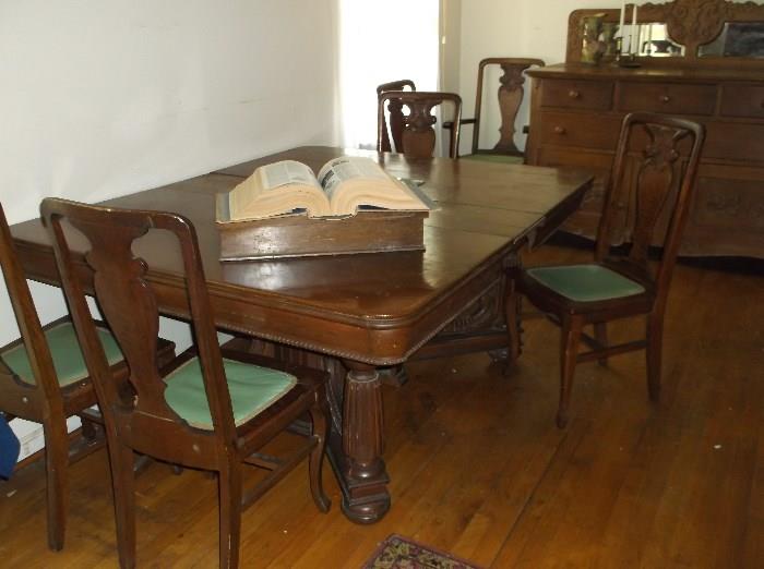 Great tiger oak dining table w/five leaves and eight chairs