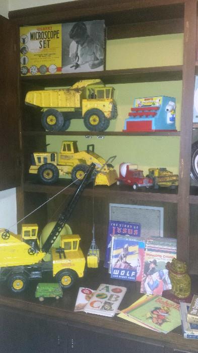 Vintage metal Tonka trucks, crane, smaller cement truck, Snoopy register (1950s), children's books (1950s), cast iron cat door stop, and more!