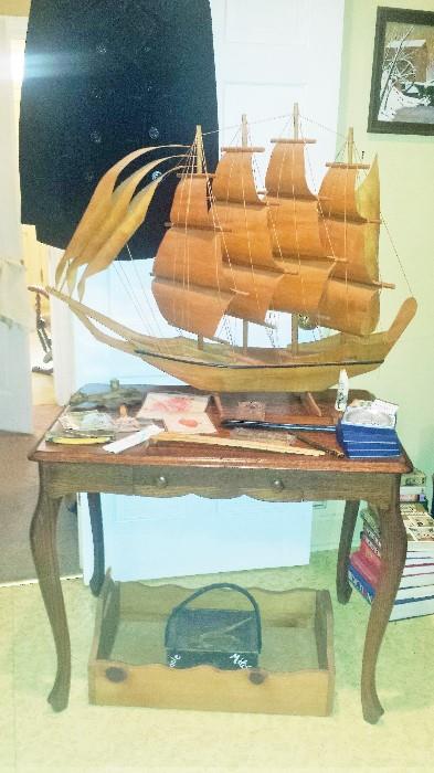 U.S. Navy WW2 era pea coat, large wooden model ship (appears to be hand made), foyer table, Geneva straight razor, paper advertising collectibles, and more!