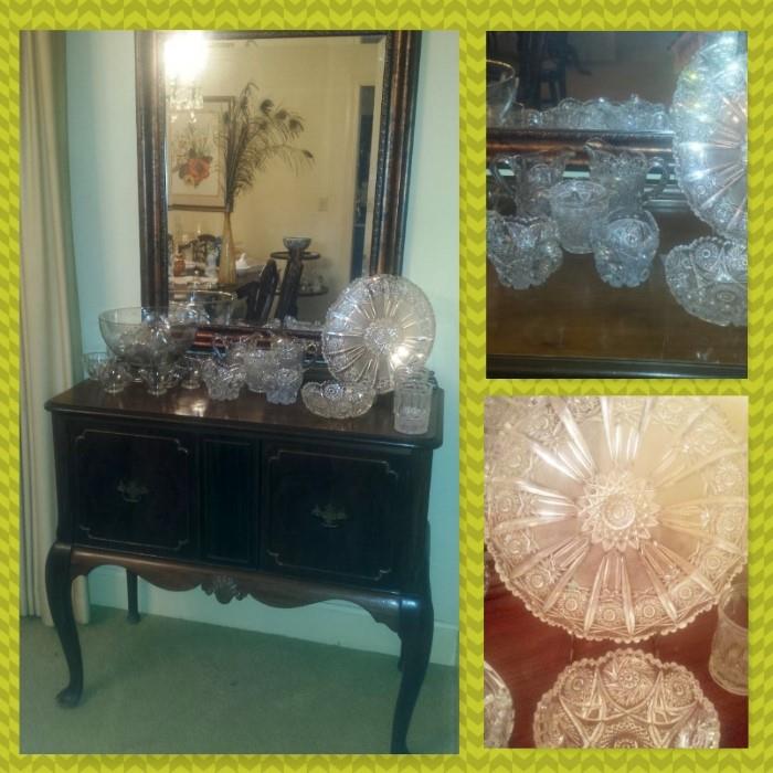 Small antique buffet, beveled glass mirror, American brilliant cut glass, and other glass.