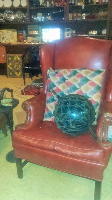 Leather wing back chair, smoker's stand, large antique buoy with net. 