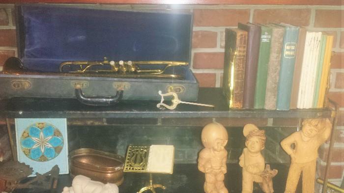 One of two vintage trumpets (Manhattan & King), also hymnals and other decorator pieces.