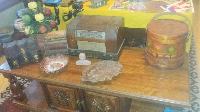 Coffee table, antique firkin or sugar pail, Philco tube radio, antique books, wooden apple arrangement, and more.