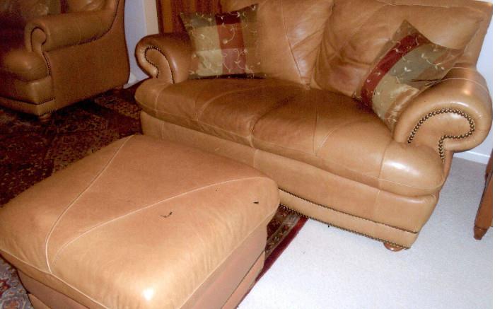Pair of Italian leather love seats and ottoman.