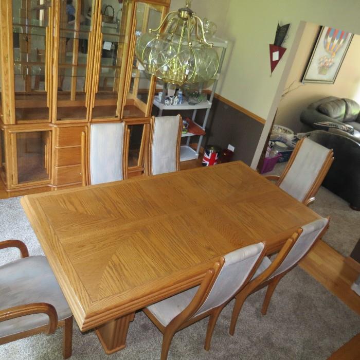 Fairmont Designs dining room table 64"rectangular oak table with two 16" leaves 4 side chairs and 2 arm chairs and matching china cabinet