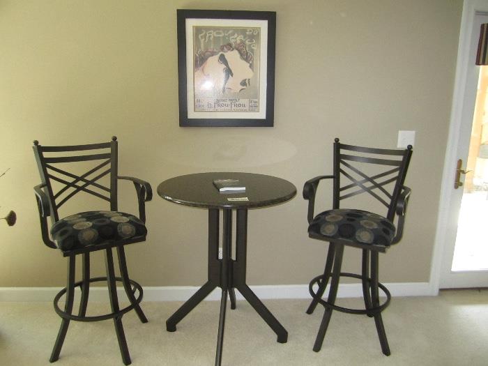 black wrought iron cocktail table with bar height stools
