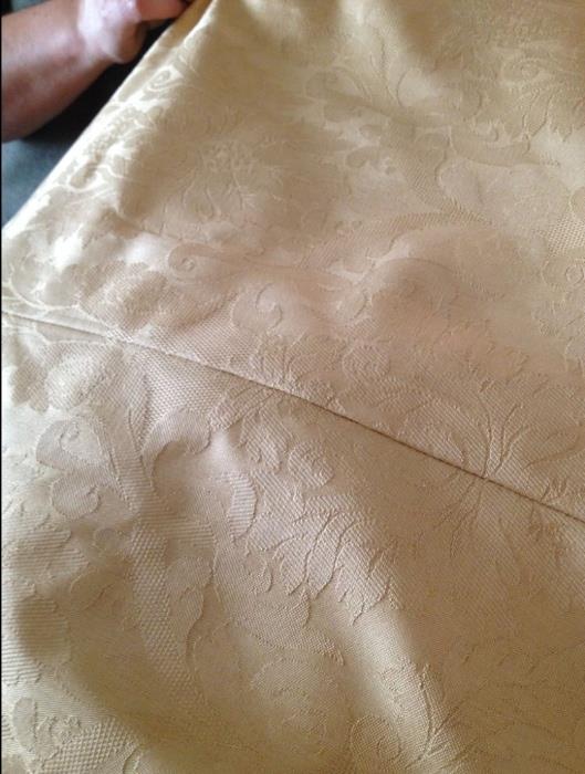 Close-up of gold lined draperies.