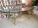 Oval glass and brass base coffee table.