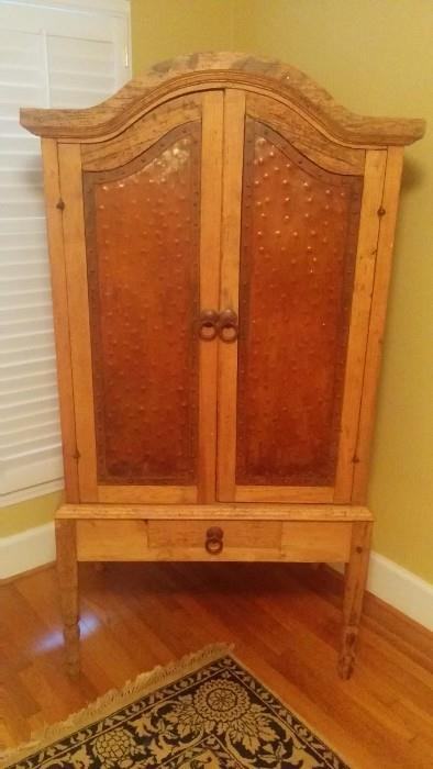 Hammered copper panel armoire.