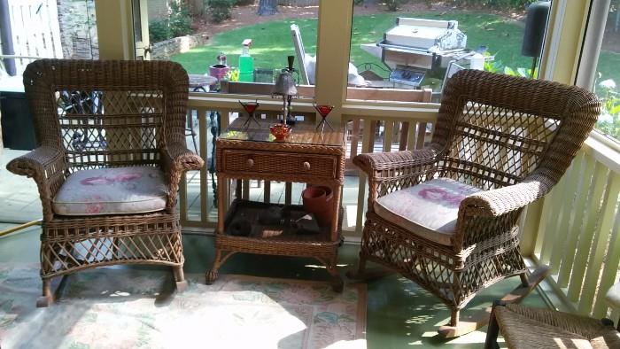 Pair of wicker rocking chairs, w/wicker side table and screened-porch-dictated candles and pottery doo dads.