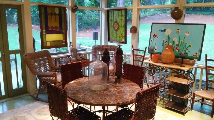 Nice shot of one each of the two pair of stained glass panels, round marble topped dining table, set of 4 woven leather sling chairs, folk art by Atlanta artist Stephanie Durham, "What Chall Doing?"