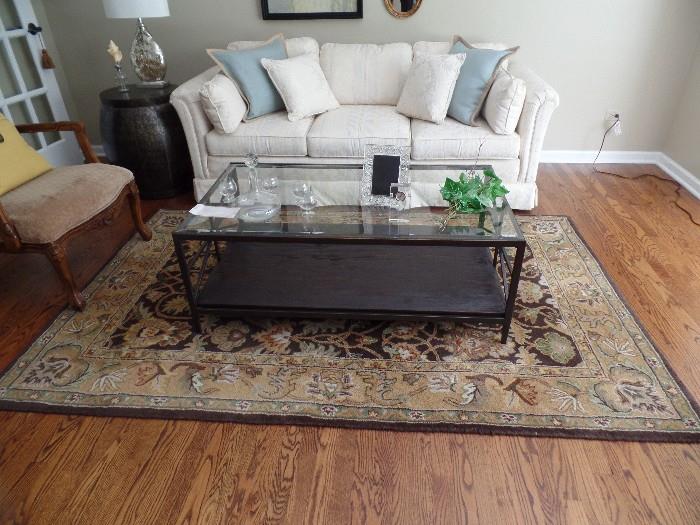 Stunning Living room furniture- couch; area rug; glass top coffee table; end table; lamp and frames.