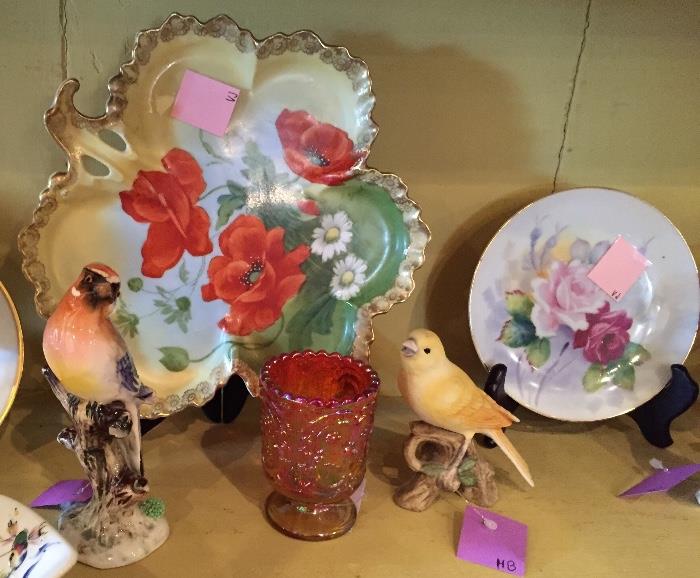Painted plates and bird figurines.