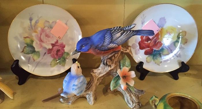 Painted small plates and bird figurine.