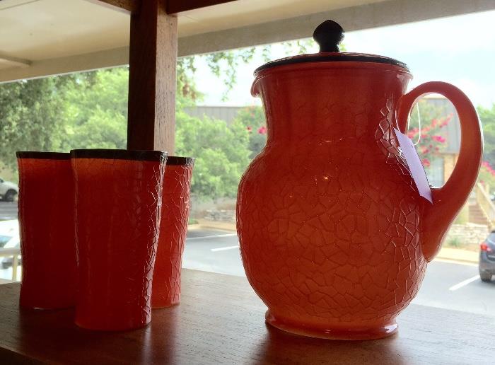 Vintage orange glass pitcher and glasses.