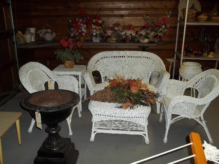 White wicker porch set with settee, two chairs, side table, fern stand and coffee table. Also lots of artificial flower arrangements, greenery and silk flowers.