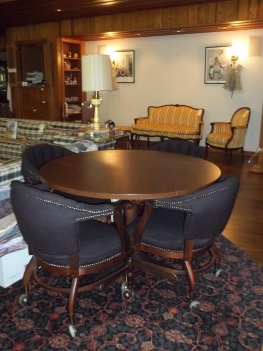 The perfect size round wood table with four matching chairs (on wheels).