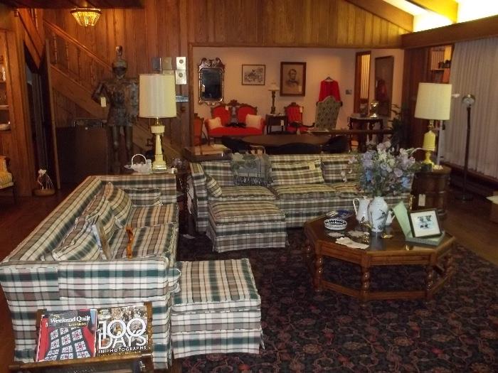 Two full-size plaid sofas with patching ottoman